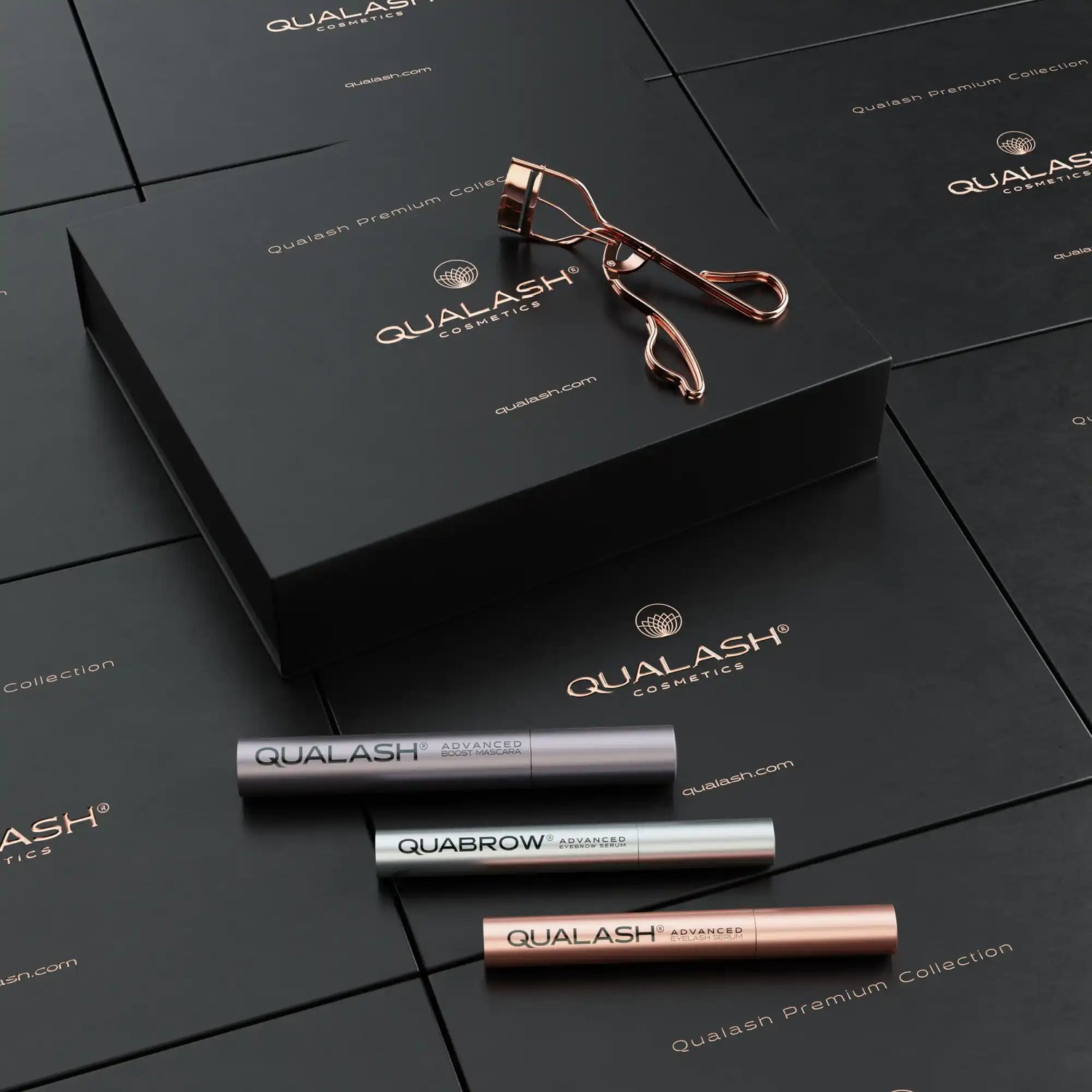 Qualash Collection – flatlay with peptide mascara, serums and rose gold curler
