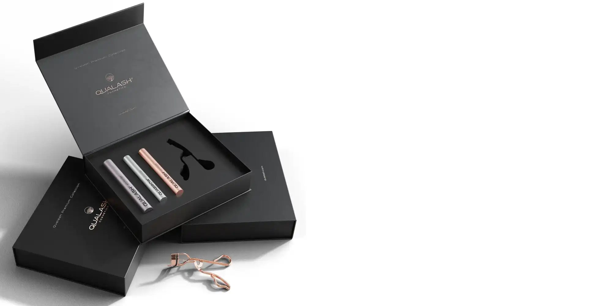 QUALASH Premium Collection Gift Set with eyelash serum, brow serum, peptide mascara, and rose gold eyelash curler in luxury box