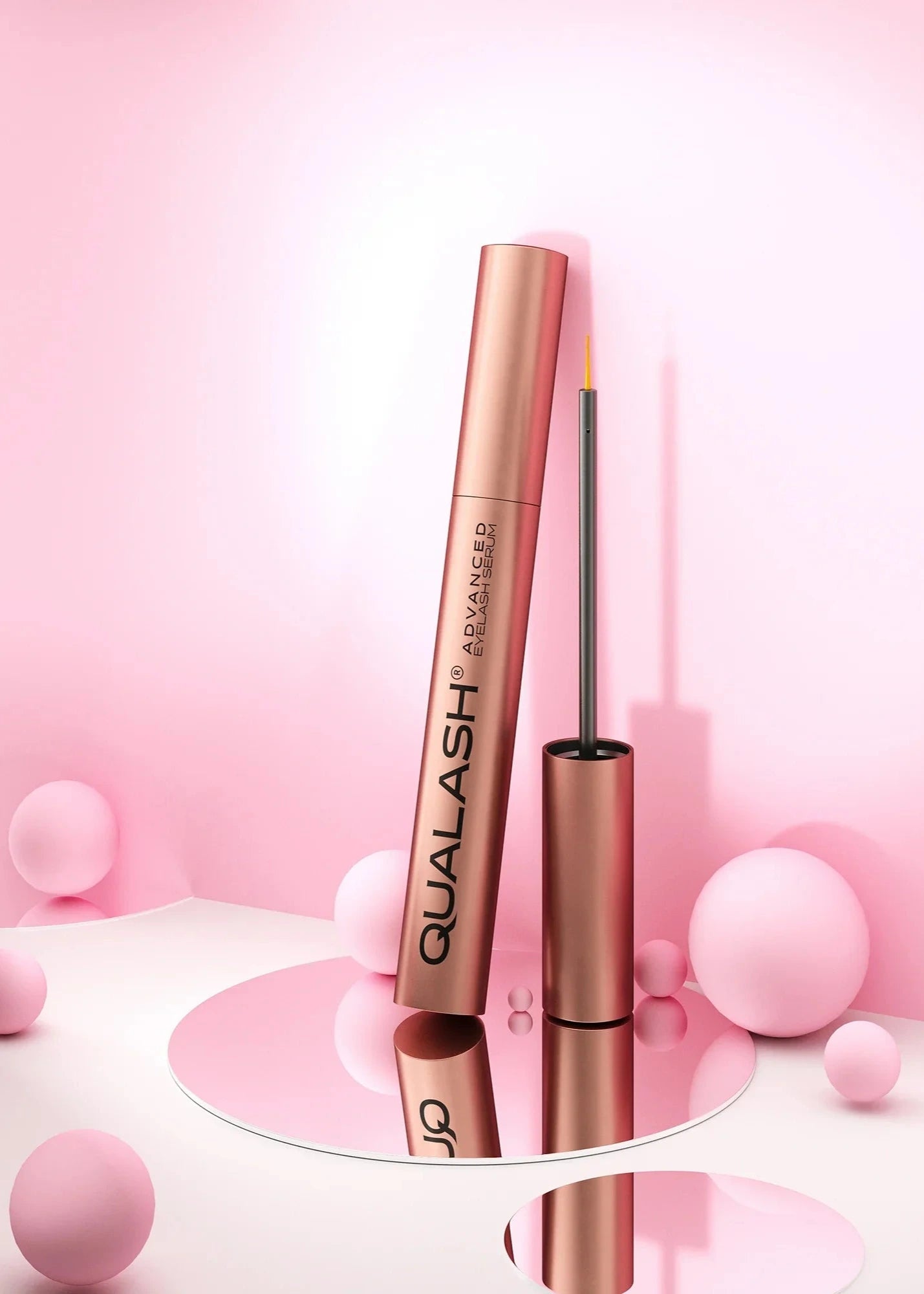 QUALASH Advanced Eyelash Serum on pink background with mirror reflection