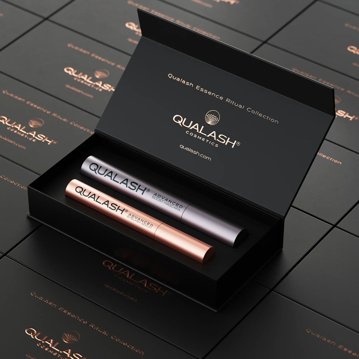 QUALASH Ritual Collection set opened on top of stacked branded gift boxes – elegant top-down perspective.