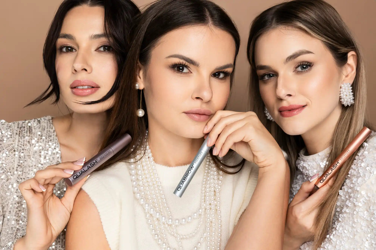 Three women holding mascara tubes.