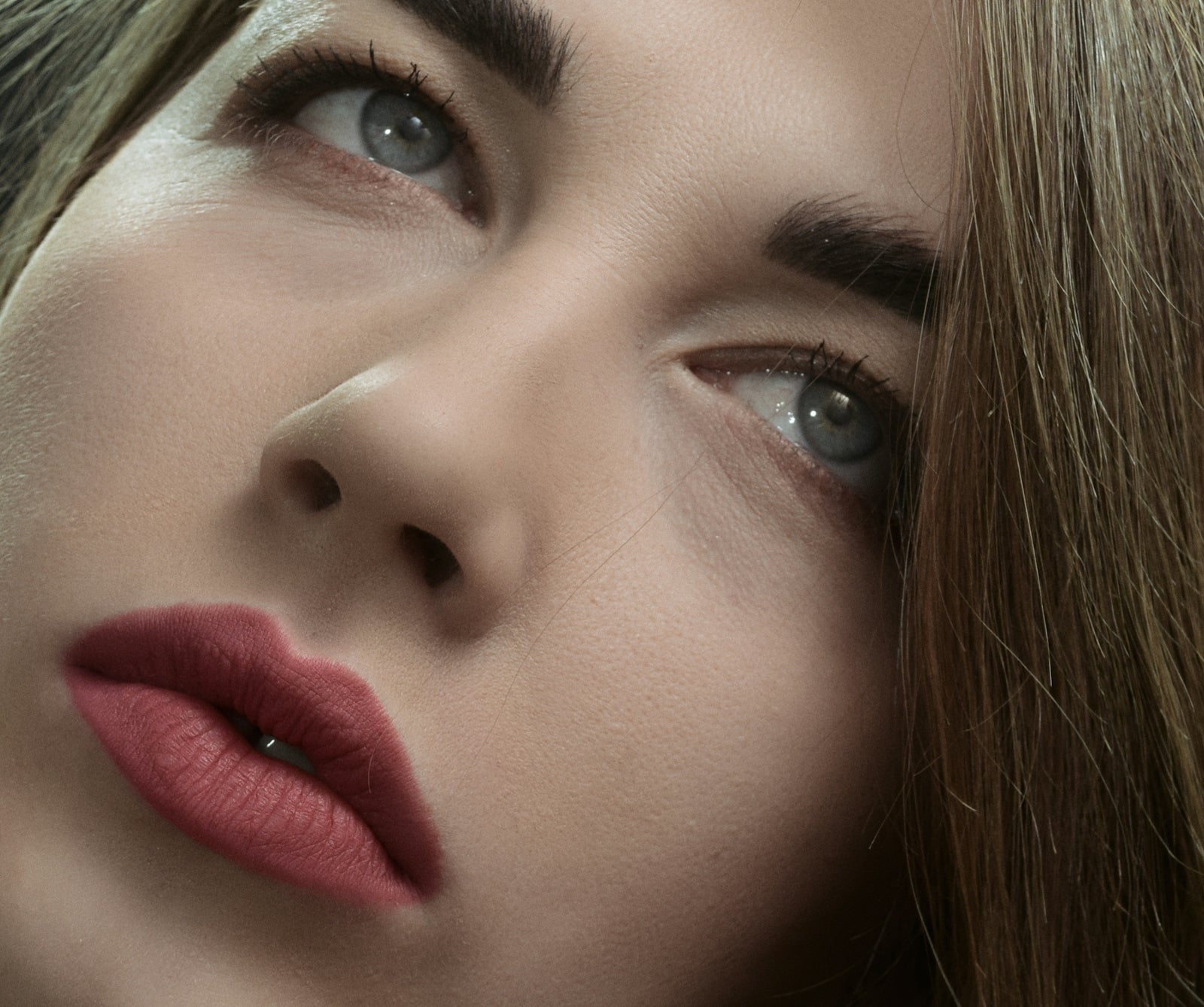 a close up of a woman's face with a red lipstick