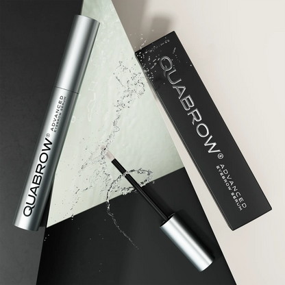 QUABROW Advanced Eyebrow Serum DUO with packaging and splash visual effect, laid on geometric surface