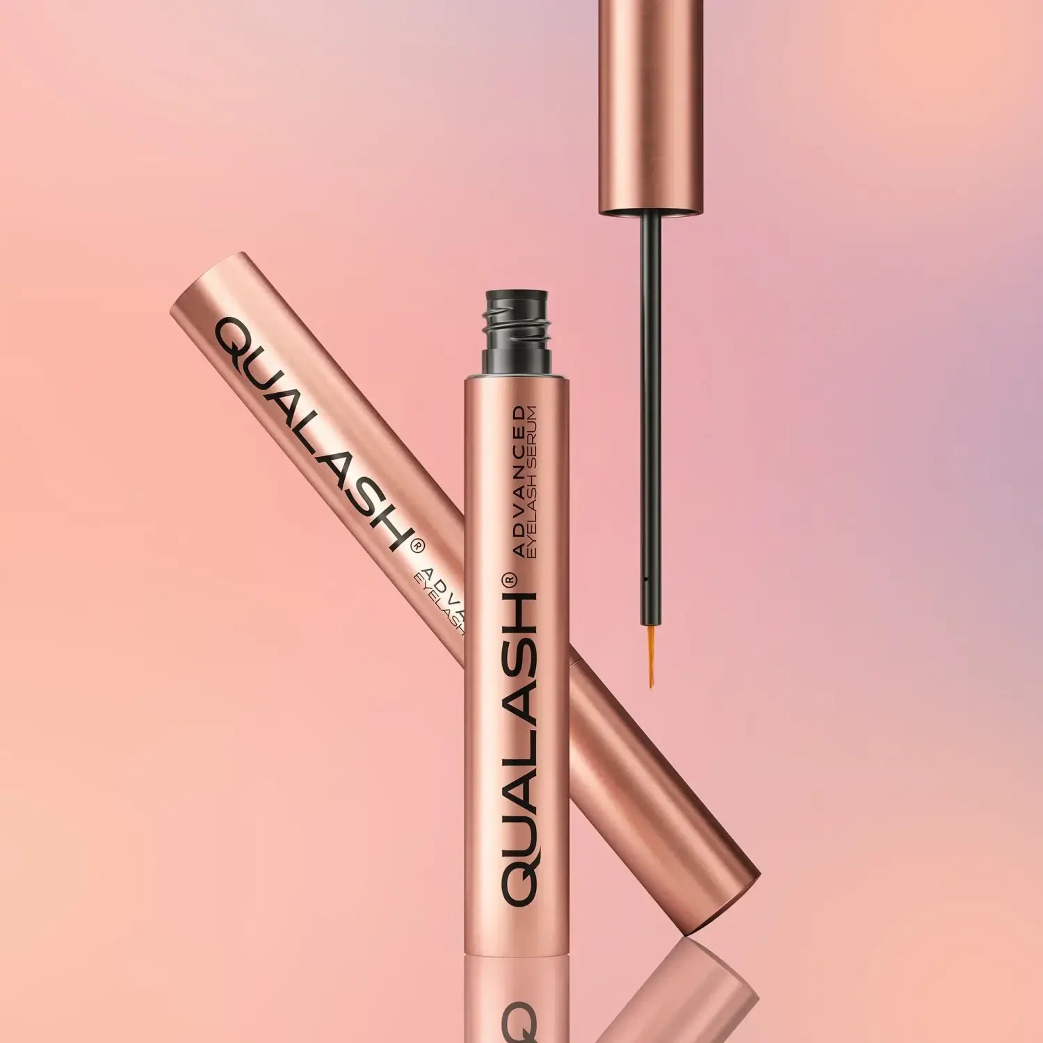 QUALASH Advanced Eyelash Serum in rose gold packaging on a pastel background