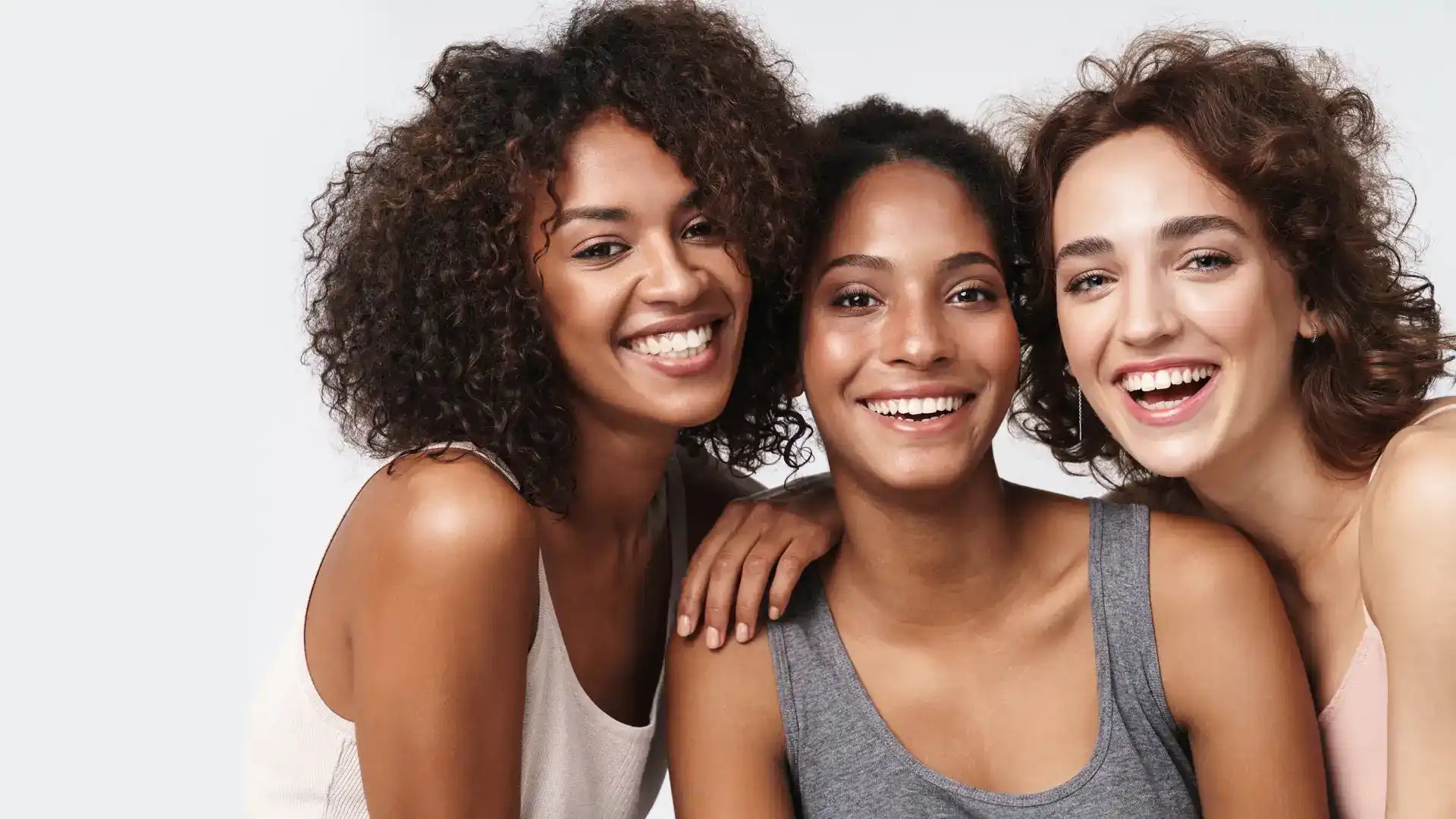 Diverse group of smiling women representing the power of QUALASH serums for lashes and brows