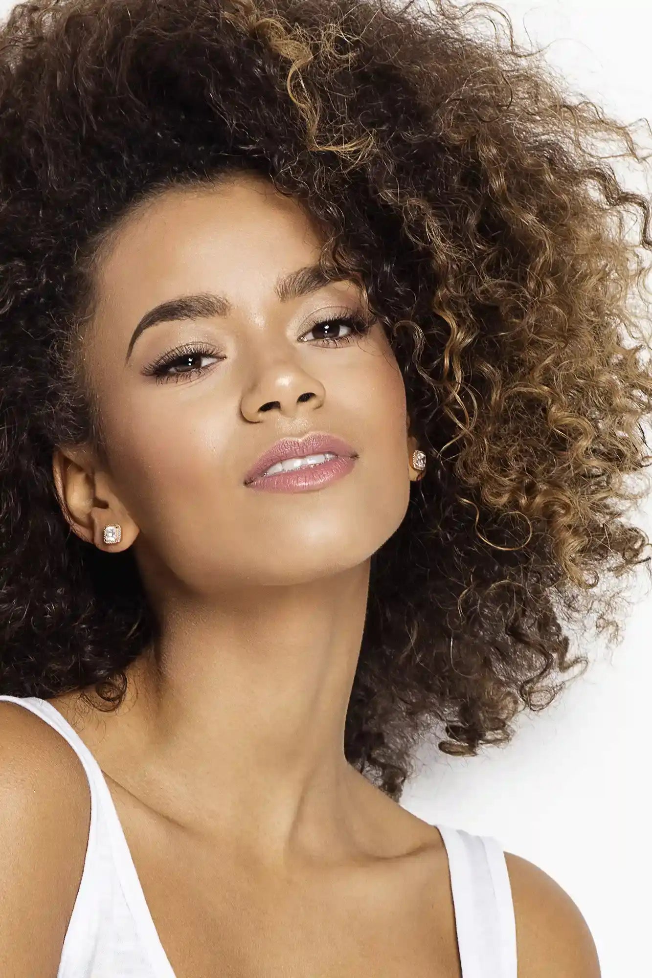  Confident woman with flawless lashes and brows using Qualash serums